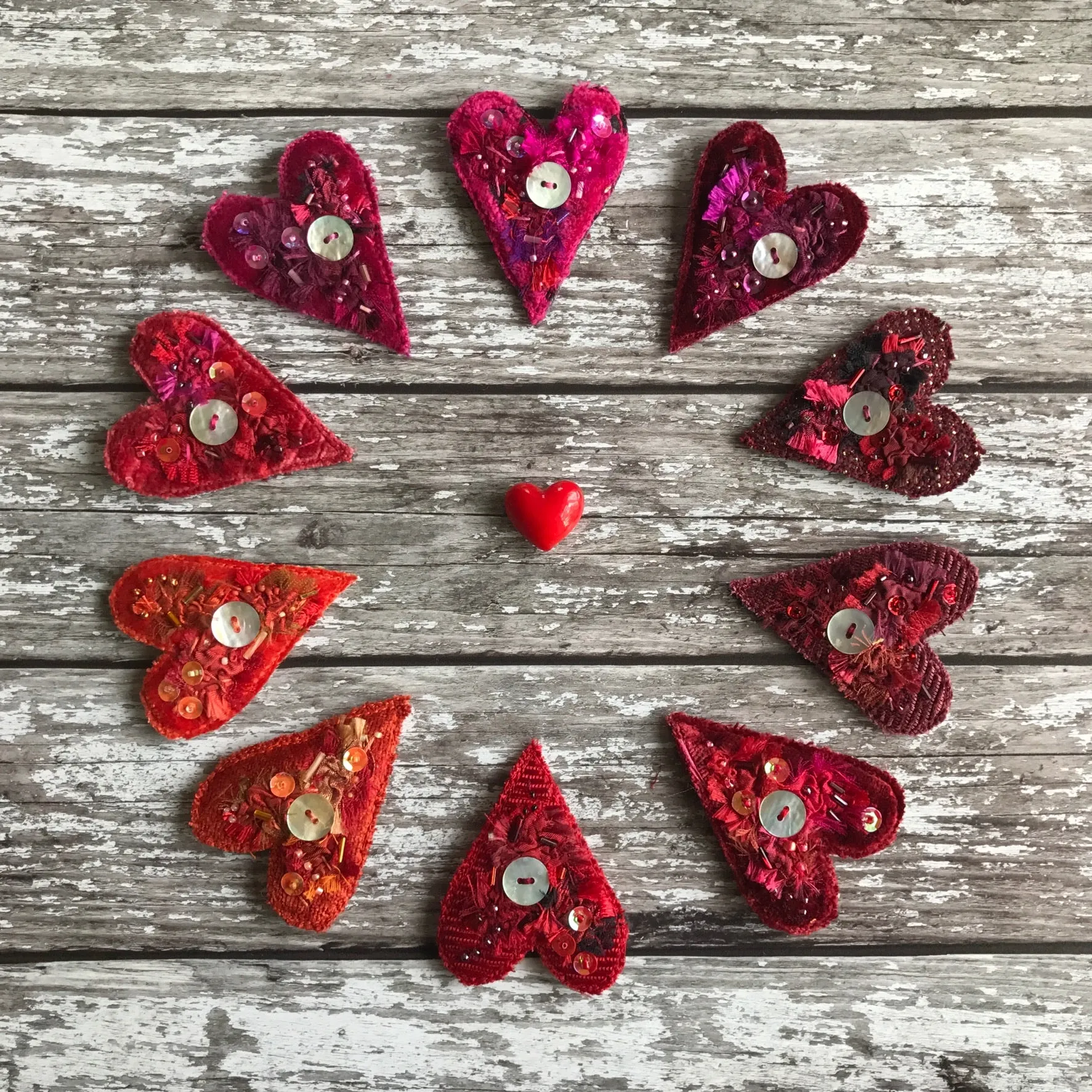 Fabric heart brooches in reds