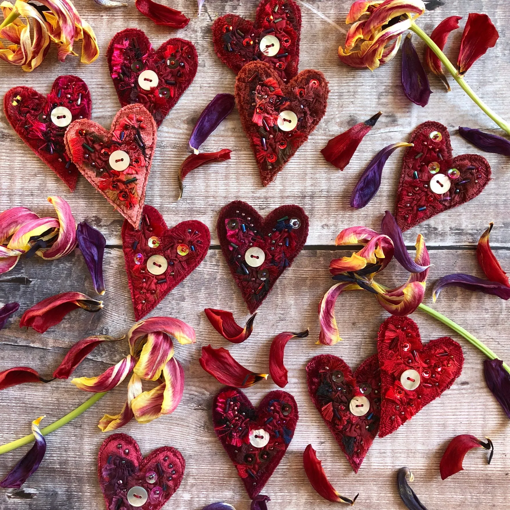 Fabric heart brooches in reds