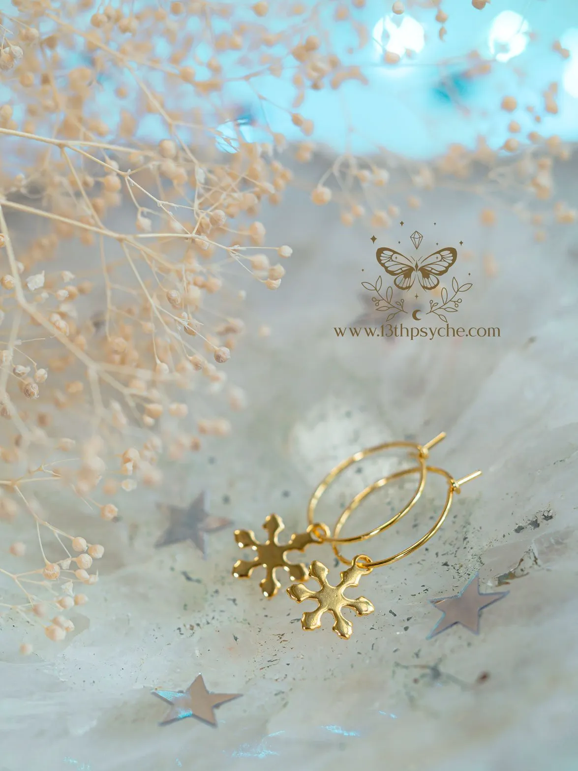 Hypoallergenic gold hoop earrings with snowflake charm