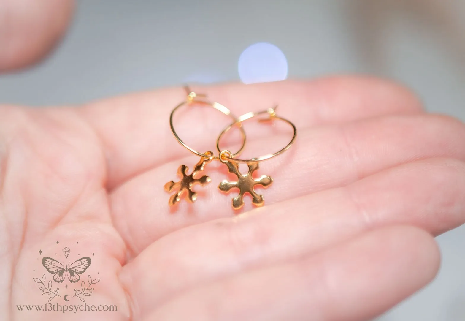 Hypoallergenic gold hoop earrings with snowflake charm