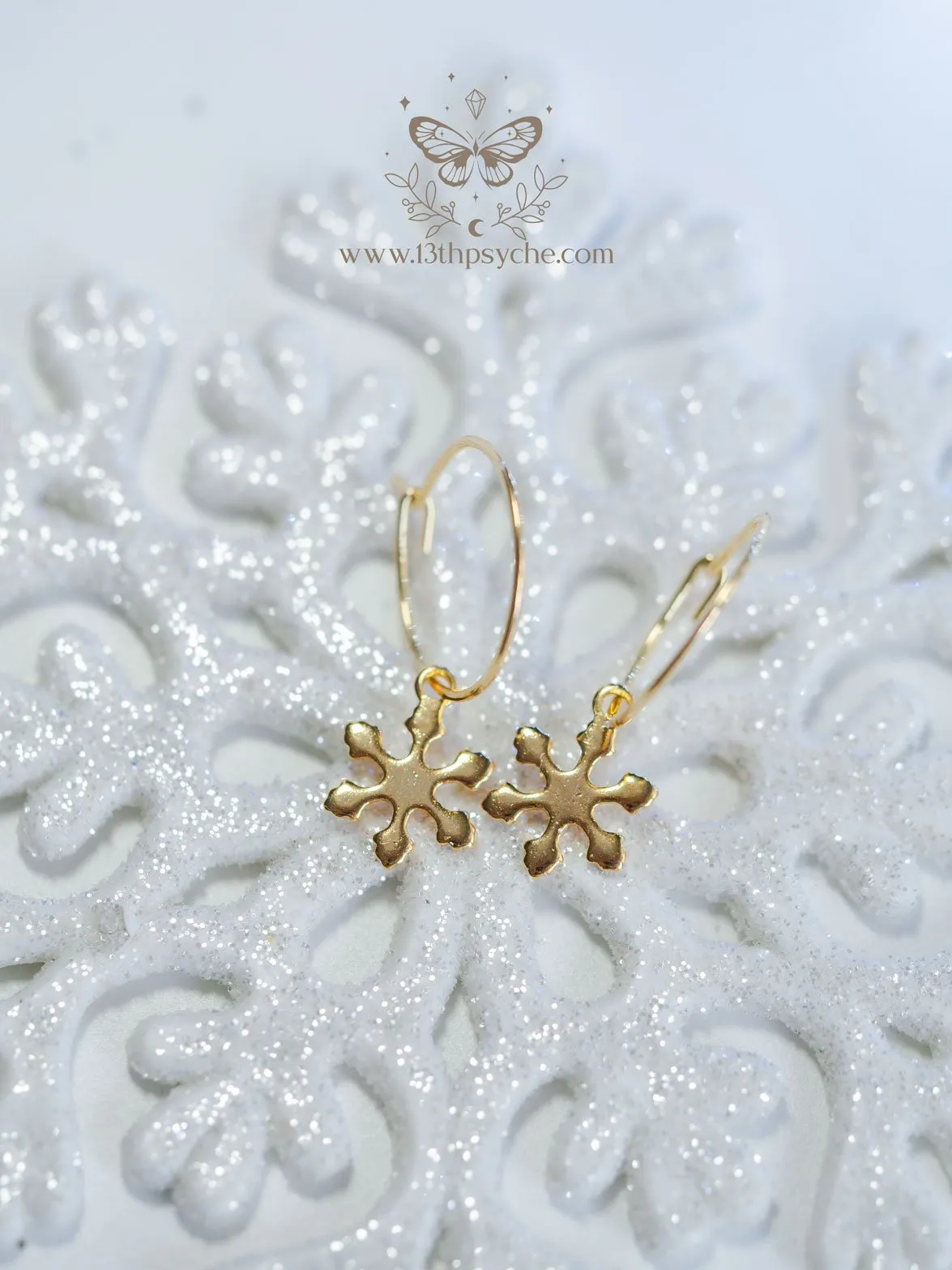 Hypoallergenic gold hoop earrings with snowflake charm