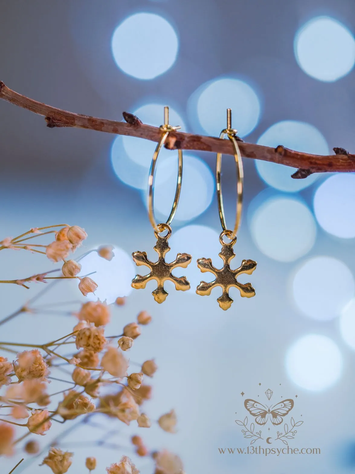 Hypoallergenic gold hoop earrings with snowflake charm