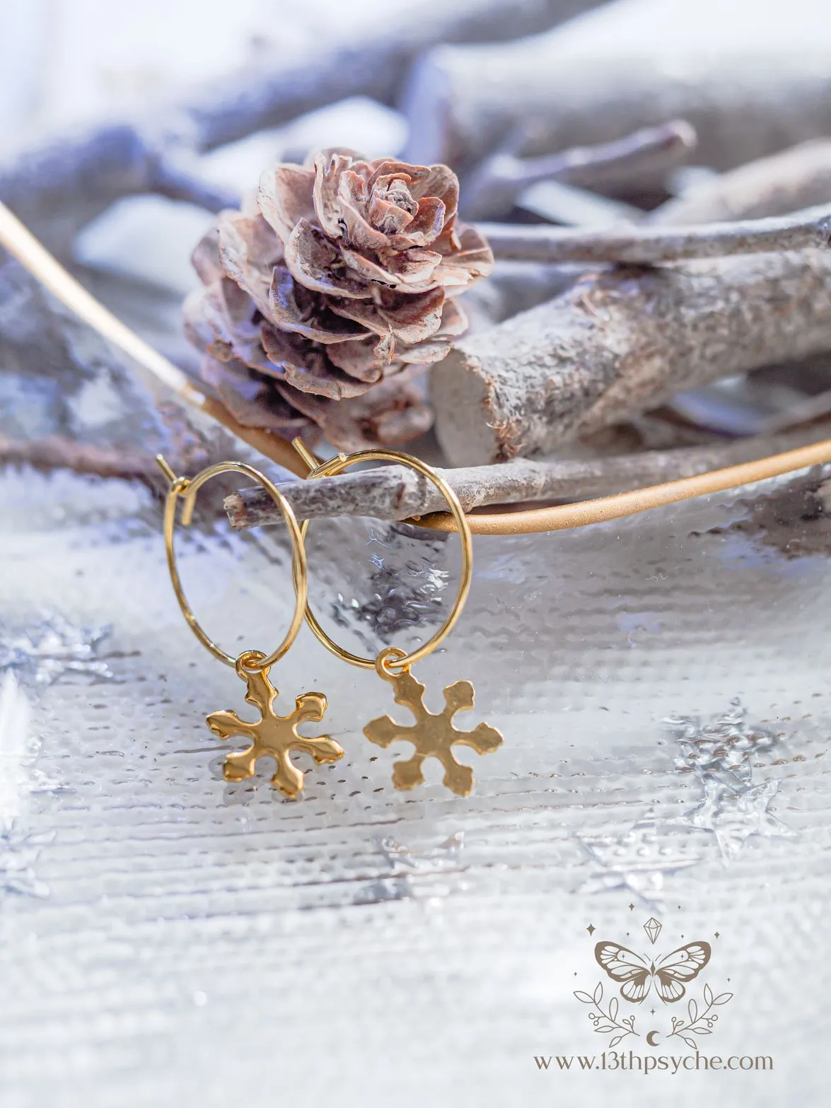 Hypoallergenic gold hoop earrings with snowflake charm